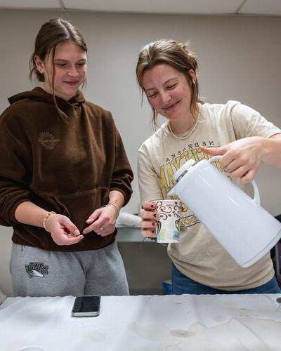 NWU students pour a cup of coffee.